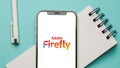 Adobe Firefly logo displayed on mobile phone screen, AI Art generator tool