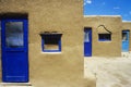 Adobe houses with blue windows and door frames