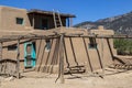 Adobe Mud multi-storied buildings in pueblo village that have been continuously inhabited for over 1000 years with New Mexico moun Royalty Free Stock Photo