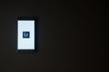 Adobe photoshop lightroom logo on smartphone screen on black background. Royalty Free Stock Photo