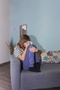 Adolescent girl crying on the couch in the therapy room during her session. Royalty Free Stock Photo