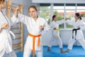 Adolescent girl honing punching techniques during kumite at karate training Royalty Free Stock Photo