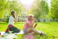 Adolescent girls having fun in the park - blowing soap bubbles. Royalty Free Stock Photo