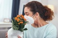 Adolescent lady testing her protective mask with flower pollen