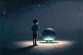 The adolescent male pulled on the massive orb, which was partially buried in the ground and illuminated by the night sky filled Royalty Free Stock Photo