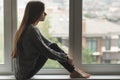 Adolescent trouble, sad depressed young woman on the window,unhappy teenager thinks about negative things, problems, suffers Royalty Free Stock Photo