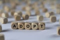 Adopt - cube with letters, sign with wooden cubes