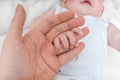 Adoption baby concept. Man holds little child's hand Royalty Free Stock Photo