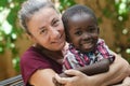 Adoption symbol - Woman adopts a little African boy Royalty Free Stock Photo