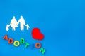 Adoption word and family figure for adopt child concept on blue background top view mock up