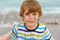 Adorable active little kid boy having fun on Miami beach, Key Biscayne. Happy cute child relaxing, playing and enjoying