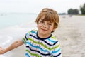 Adorable active little kid boy having fun on Miami beach, Key Biscayne. Happy cute child relaxing, playing and enjoying