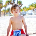 Adorable active little kid boy having fun on Miami beach, Key Biscayne. Happy cute child relaxing, playing and enjoying