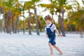 Adorable active little kid boy having fun on Miami beach, Key Biscayne. Happy cute child relaxing, playing with sand and Royalty Free Stock Photo