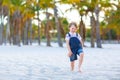 Adorable active little kid boy having fun on tropical beach of island. Happy cute child relaxing, playing, enjoying Royalty Free Stock Photo