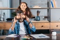 Adorable african american girl closing fathers eyes, standing Royalty Free Stock Photo