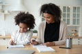 Adorable african american girl enjoying studying with mommy. Royalty Free Stock Photo