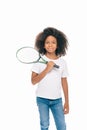 adorable african american girl holding tennis racquet and smiling at camera Royalty Free Stock Photo