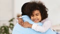 Adorable African American girl hugging her grandpa at home Royalty Free Stock Photo