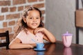 Adorable african american girl playing with toy kitchen utensils Royalty Free Stock Photo