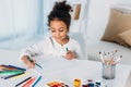 adorable african american kid drawing with felt pens