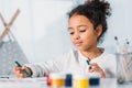 adorable african american kid painting with felt pens