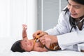 Adorable African and Asian newborn baby one month old girl check up examines by pediatrician. Doctor woman using stethoscope Royalty Free Stock Photo