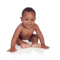 Adorable african baby in diaper sitting on the floor Royalty Free Stock Photo