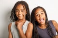 Adorable african twin little girls on studio gray background doing some grim and funny face Royalty Free Stock Photo