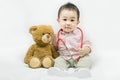 Adorable asian baby boy in pink shirt plays in doctor toy bear and red stethoscope.Health care and medical concept. Royalty Free Stock Photo