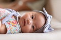 Adorable Asian baby girl lying on bed looking at camera.Cute little baby smiling and happiness relaxing in bed.Portrait of asian Royalty Free Stock Photo