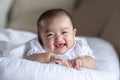 Adorable Asian baby girl lying on bed looking at camera.Cute little baby smiling and happiness relaxing in bed.Portrait of asian Royalty Free Stock Photo