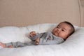 Adorable Asian baby girl lying on bed looking at camera.Cute little baby smiling and happiness relaxing in bed.Portrait of asian Royalty Free Stock Photo