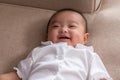 Adorable Asian baby girl lying on bed looking at camera.Cute little baby smiling and happiness relaxing in bed.Portrait of asian Royalty Free Stock Photo
