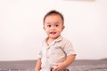 Adorable asian baby boy sitting in bedroom,Happy and laughing new born kid Royalty Free Stock Photo