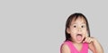 Adorable Asian child thinking isolated on a grey background with space for text Royalty Free Stock Photo