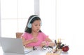 Adorable Asian girl boring class at home watching the watch for times up, kids refuse online education want to go out, school girl Royalty Free Stock Photo