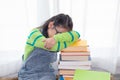 Adorable Asian girl pay attention looking to stack of books, elementary school girl worry to reading book or get headache, kid in