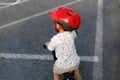 Adorable Asian kid boy Toddler age 1-year-old, Wearing a Safety Helmet and Learning to Ride a Balance Bike in the Play Space Royalty Free Stock Photo