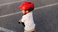 Adorable Asian kid boy Toddler age 1-year-old, Wearing a Safety Helmet and Learning to Ride a Balance Bike in the Play Space Royalty Free Stock Photo