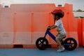 Adorable Asian kid boy Toddler age 1-year-old, Wearing a Safety Helmet and Learning to Ride a Balance Bike in the Play Space Royalty Free Stock Photo