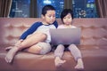 Adorable Asian kids operating a laptop at night Royalty Free Stock Photo