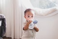 Adorable asian little baby boy drinking water from bottle at home Royalty Free Stock Photo