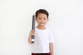 Adorable Asian little boy holding big pencil and looking camera over white background. Kid and education concept Royalty Free Stock Photo