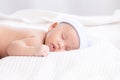 Adorable Asian newborn baby deeply sleeping smile Easter costume hat, tiny infant boy soft skin healthy sleep dream on white Royalty Free Stock Photo