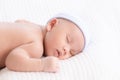 Adorable Asian newborn baby deeply sleeping smile Easter costume hat, tiny infant boy soft skin healthy sleep dream on white Royalty Free Stock Photo