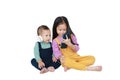 Adorable Asian older sister and little brother sharing to enjoys listening music with headphones by smartphone isolated over white