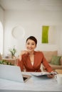 Adorable attractive smart clever young smiling woman working sitting in office at work place work station Royalty Free Stock Photo