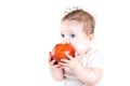 Adorable baby with big blue eyes eating red apple Royalty Free Stock Photo