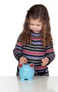 Adorable baby with a blue money-box